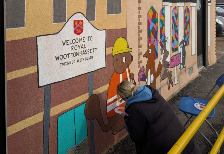 Artwork being painted on to the wall of toilets