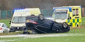One hospitalised after driver flips car up verge in dramatic crash