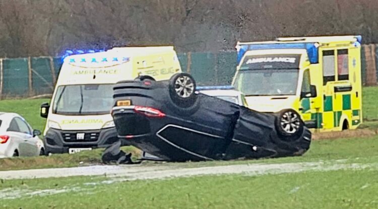 One hospitalised after driver flips car up verge in dramatic crash