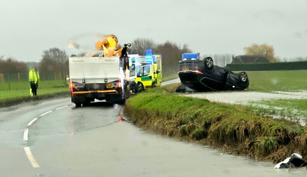One hospitalised after driver flips car up verge in dramatic crash