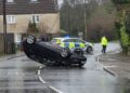 Police close busy road after car overturns in village near Westbury