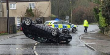 Police close busy road after car overturns in village near Westbury