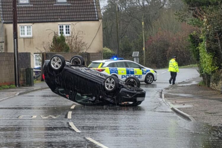 Police close busy road after car overturns in village near Westbury