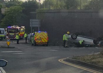 BMW flips onto roof in dramatic crash on busy Swindon junction