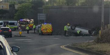 BMW flips onto roof in dramatic crash on busy Swindon junction
