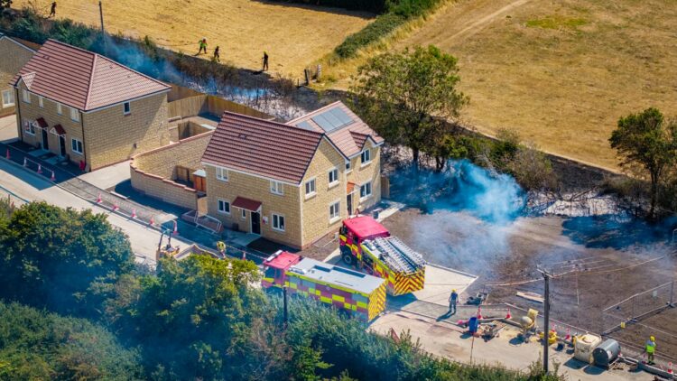 Firefighters tackle huge flames threatening new homes in Calne