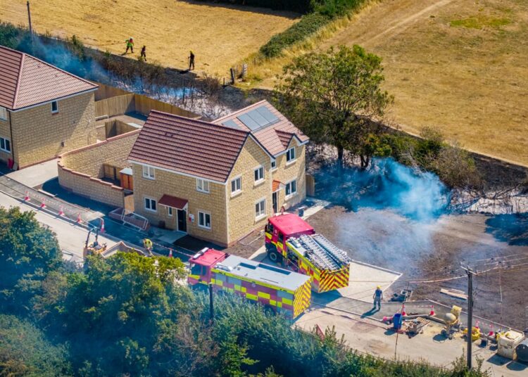 Firefighters tackle huge flames threatening new homes in Calne